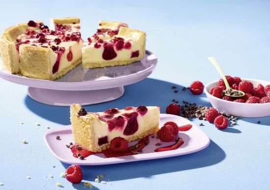 Bild von Creamy Raspberry Cheesecake mit der Beschreibung Vegane Cheesecake-Alternative mit Himbeeren, cremig auf nussigem Mürbeteig